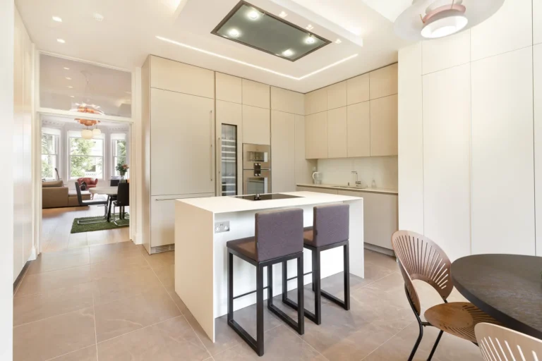 Modern kitchen renovation in London with fitted cabinets and stone worktop